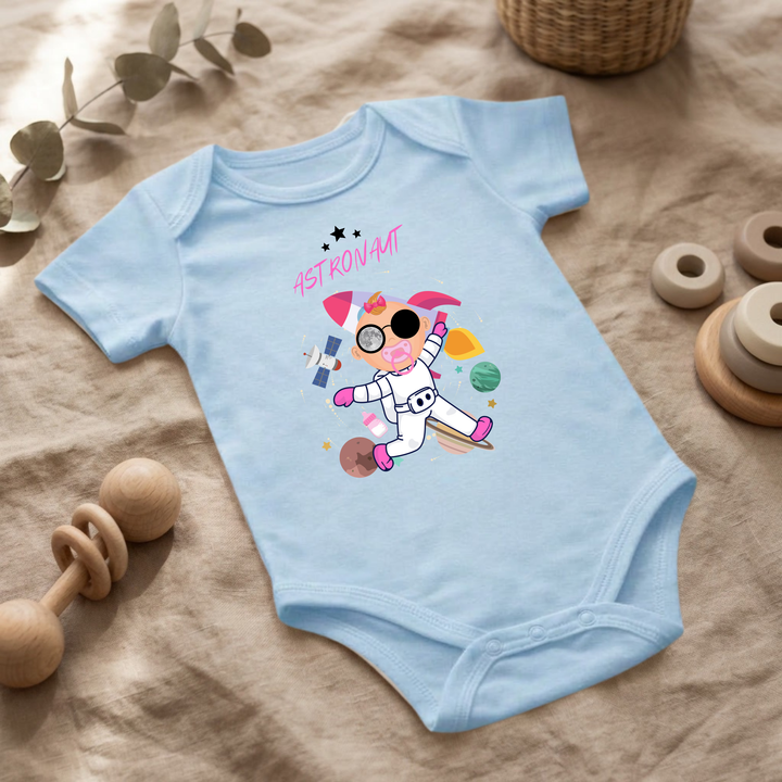 Hellblauer Baby Body für kleine Mädchen mit Astronaut Design im Flat Lay, Baby Kleidung mit Weltraum- und Sternen- Motiv, Geschenkidee für Babys von der Baby und Kleinkind- Brand TIMMY &amp; MIMMY